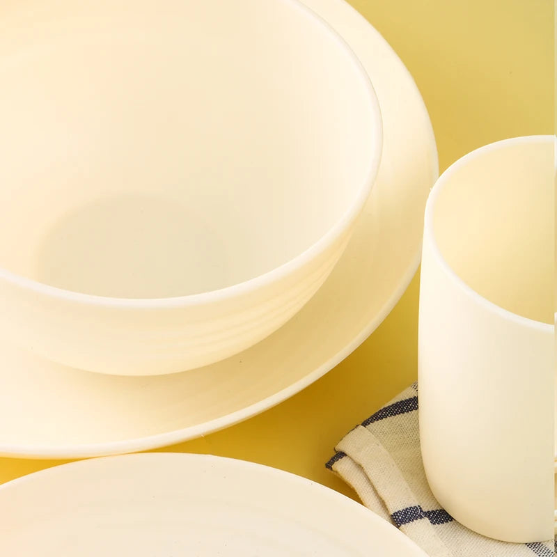 White plastic dinnerware set plate, bowl and cup